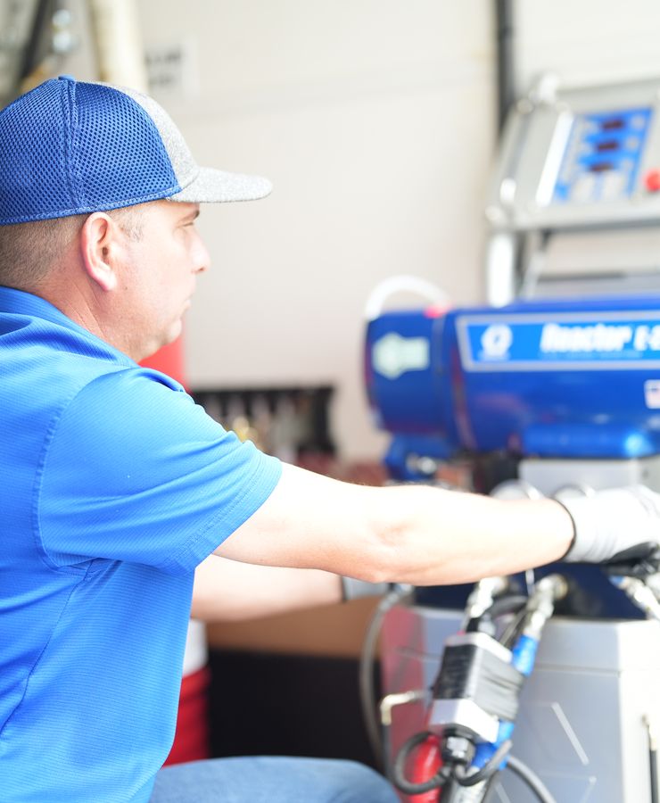 A technician operating the spray foam machine inside the RF equipment trailer.