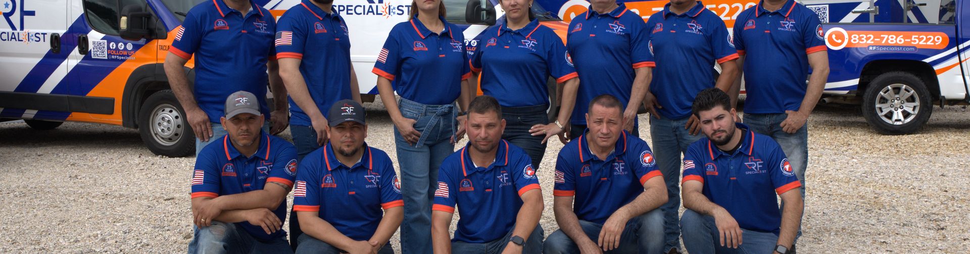 The RF Specialist team gathered in front of the company's service vans.